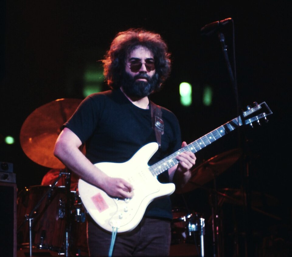 Jerry Garcia playing guitar, photographed from the audience.